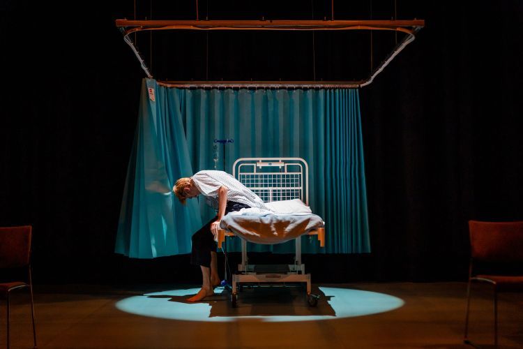 Opera singer getting out of a hospital bed on set